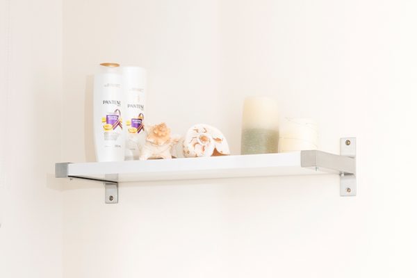 Flexi Storage Decorative Shelving Style Shelf White Gloss 600 x 190 x 24mm fitted on wall with decorations on top