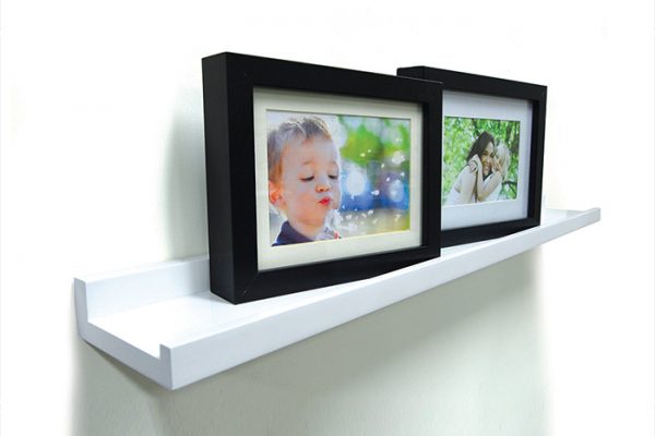 Flexi Storage Decorative Shelving Photo Shelf 1200x100x35mm fitted on wall with several photos on the shelf