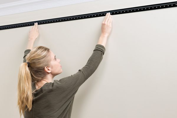 Flexi Storage Home Solutions Hang Track Black being installed onto wall